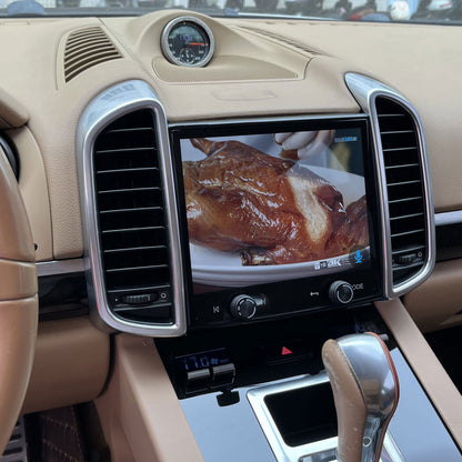Real installation of a Roadnavier Android touchscreen head unit in a Porsche Cayenne, showing the integrated screen and original dashboard trim.
